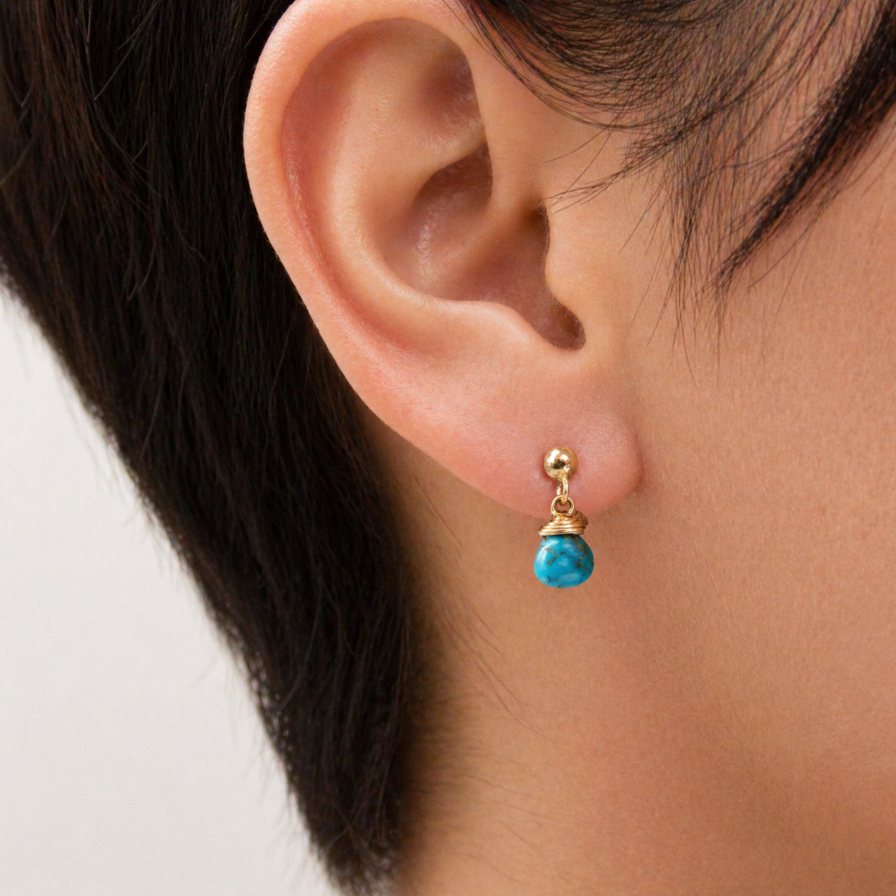 Gold-filled stud earrings with a turquoise droplet