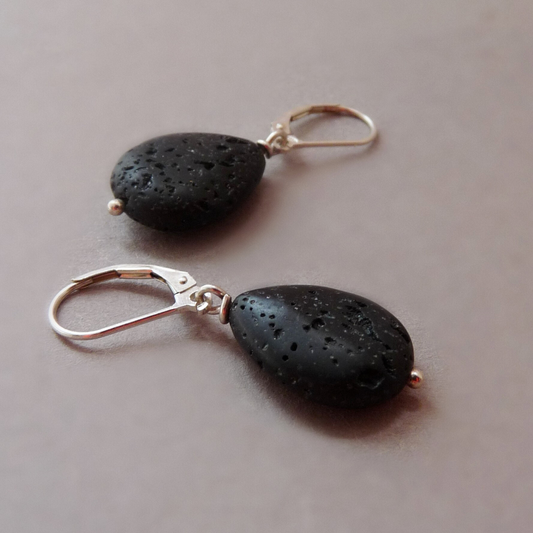 Pair of men's sterling silver drop earrings with matte black lava stone teardrops